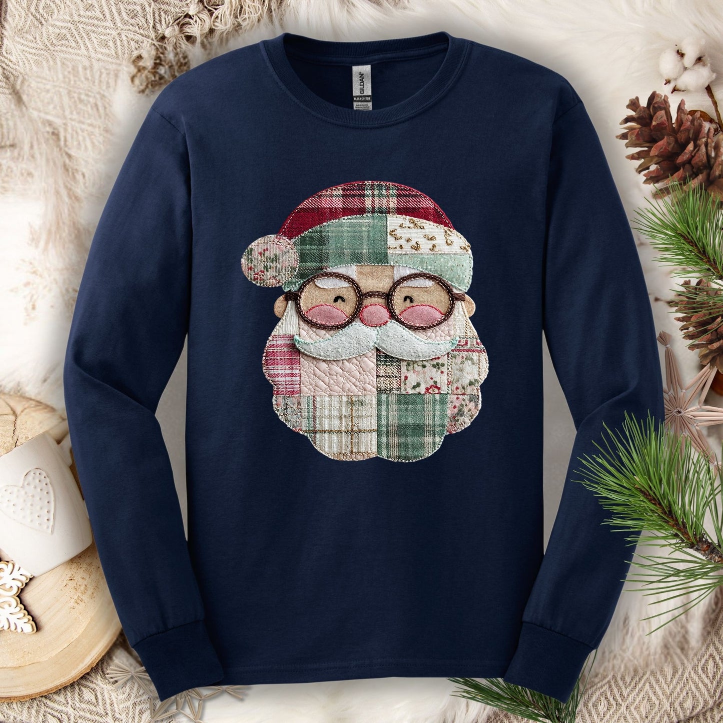 Navy long sleeve tee with a printed patchwork Santa face in red, cream, and green country-inspired fabrics.