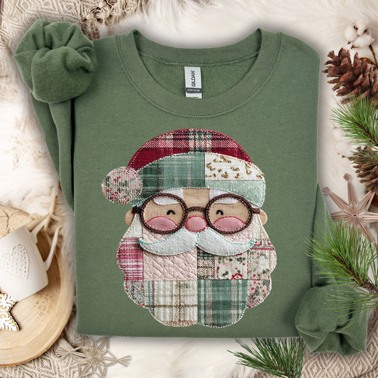 Military Green Gildan sweatshirt with a printed faux patchwork smiling Santa, surrounded by pinecones and a scrunchie.