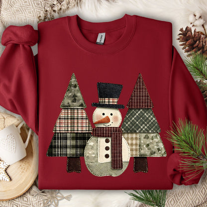 Cardinal Red Gildan sweatshirt with a faux patchwork snowman and evergreen trees in earth tones.