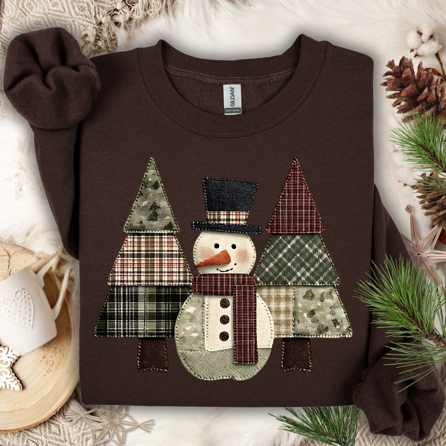 Dark Chocolate Gildan sweatshirt with a faux patchwork snowman and evergreen trees in earth tones.