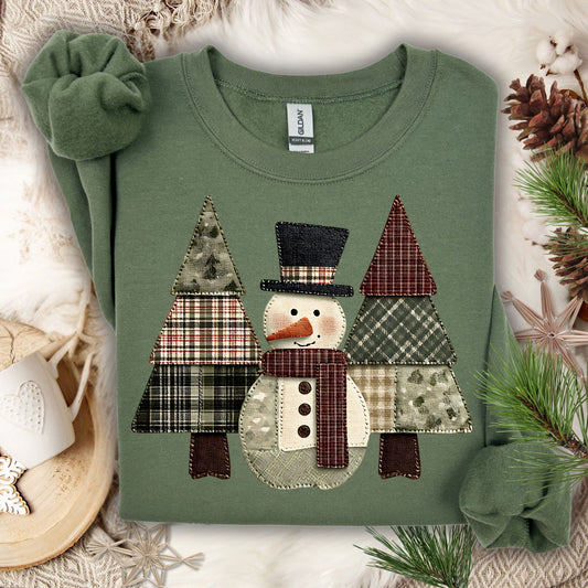 Military Green Gildan sweatshirt with a faux patchwork snowman and evergreen trees.
