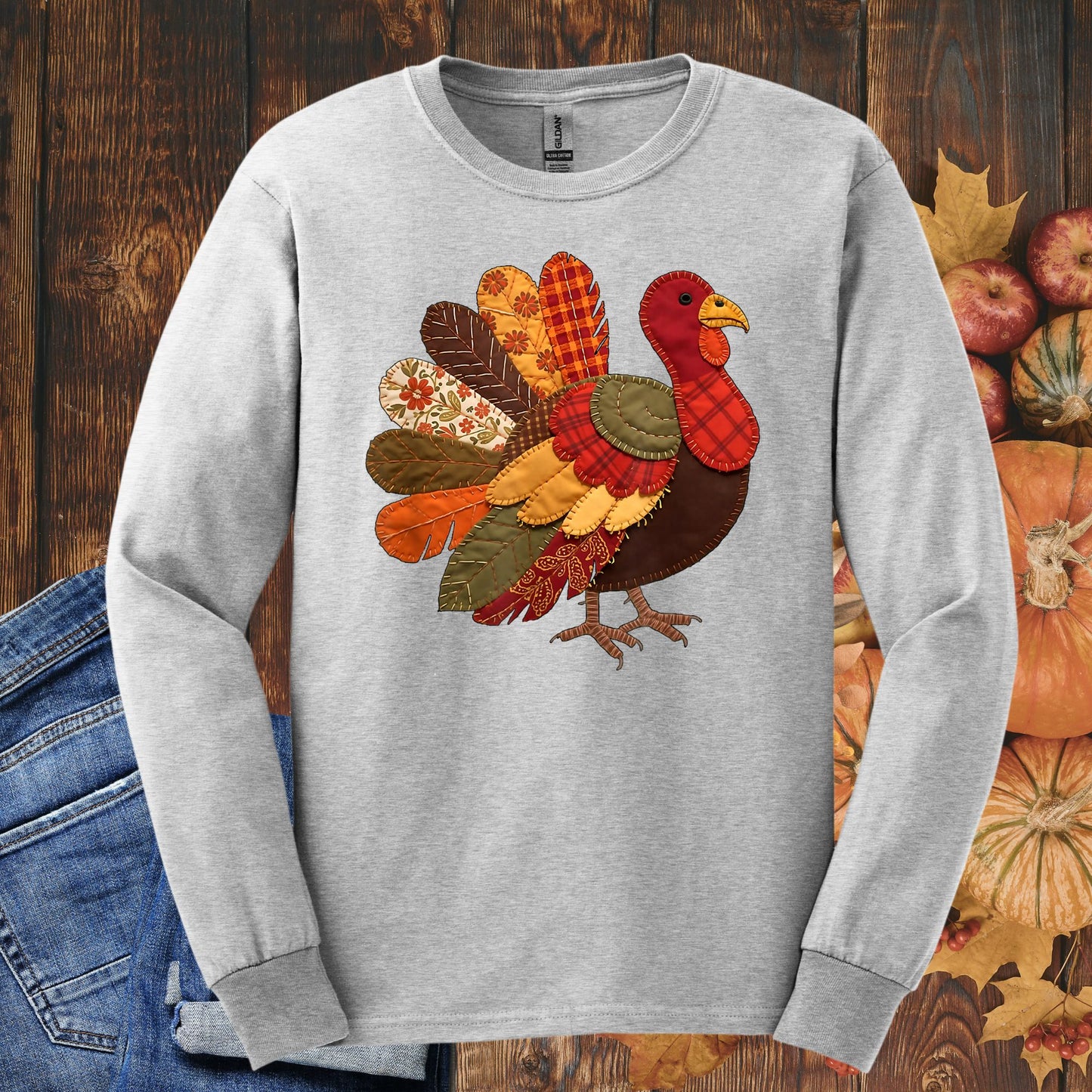 Ash long sleeve tee with a colorful faux patchwork Thanksgiving turkey design.
