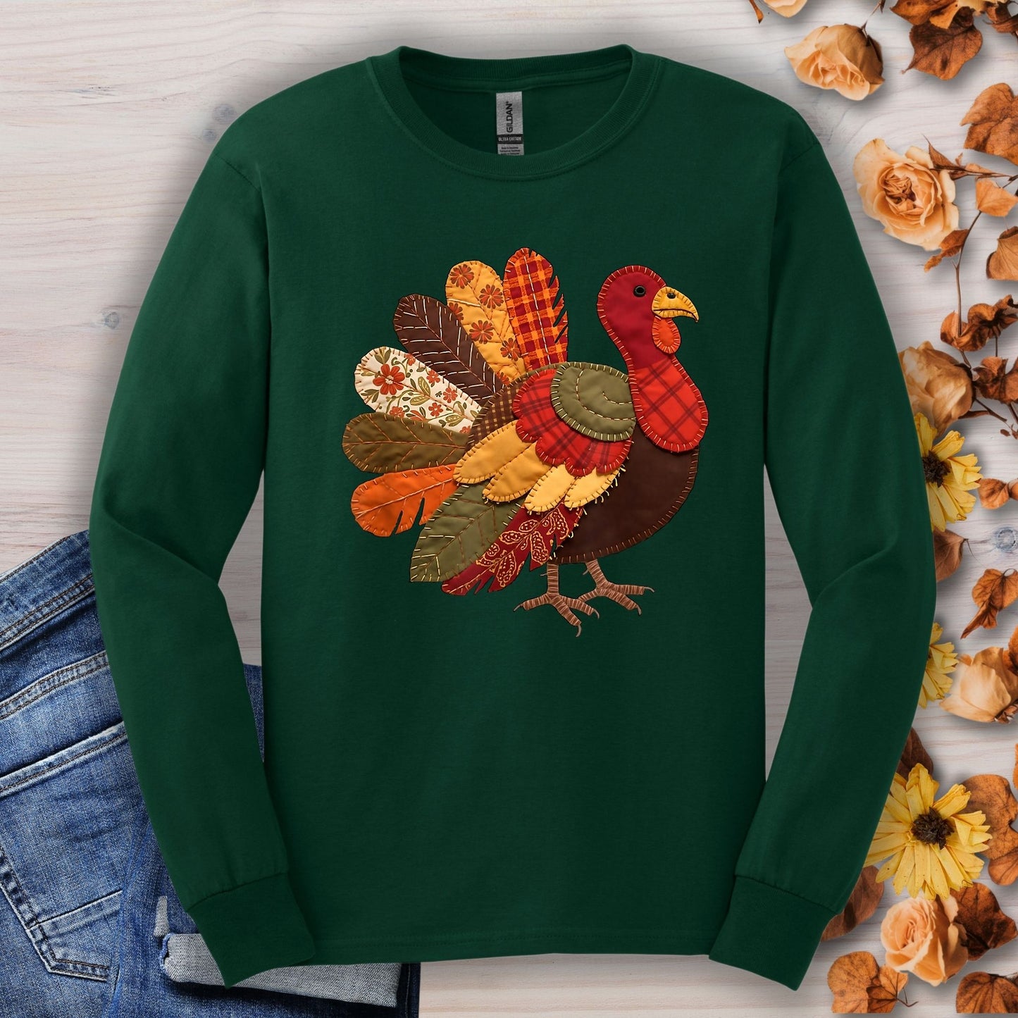 Forest green long sleeve tee with a colorful faux patchwork quilted Thanksgiving turkey design.