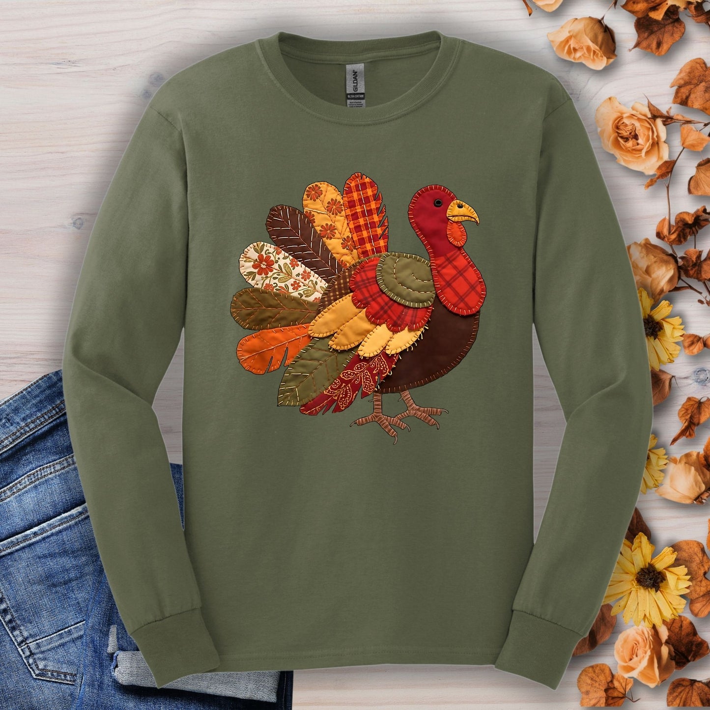 Military green long sleeve tee with a colorful faux patchwork Thanksgiving turkey design.