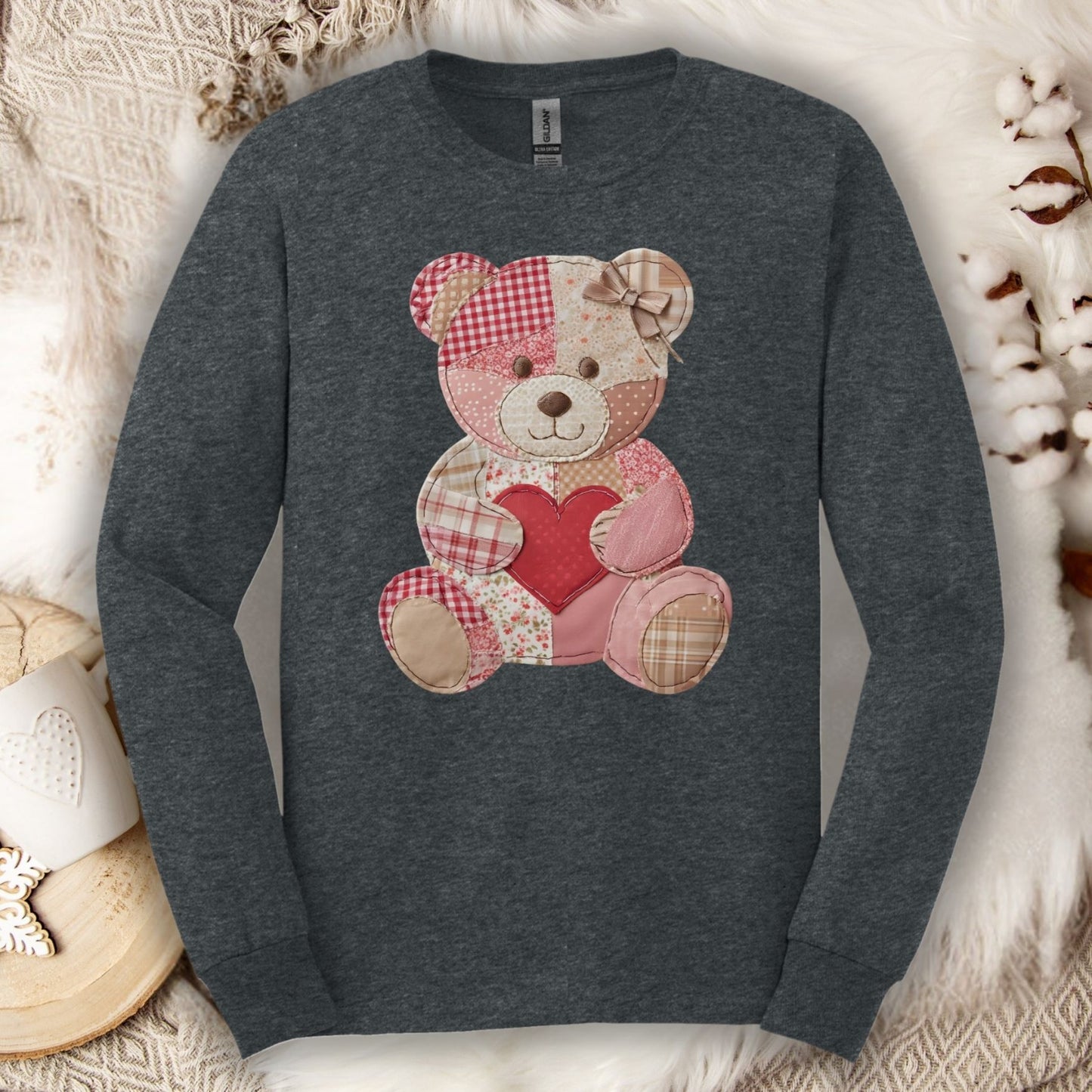 Dark Heather long sleeve tee with a patchwork teddy bear holding a red heart.