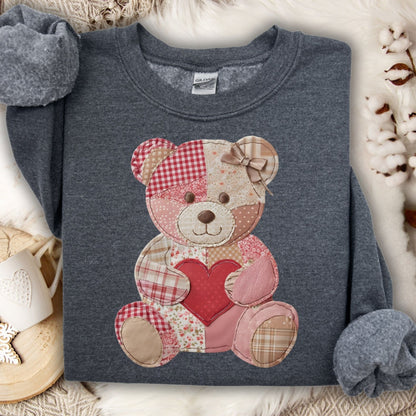 Gray crewneck sweatshirt with a vintage patchwork teddy bear holding a red heart.