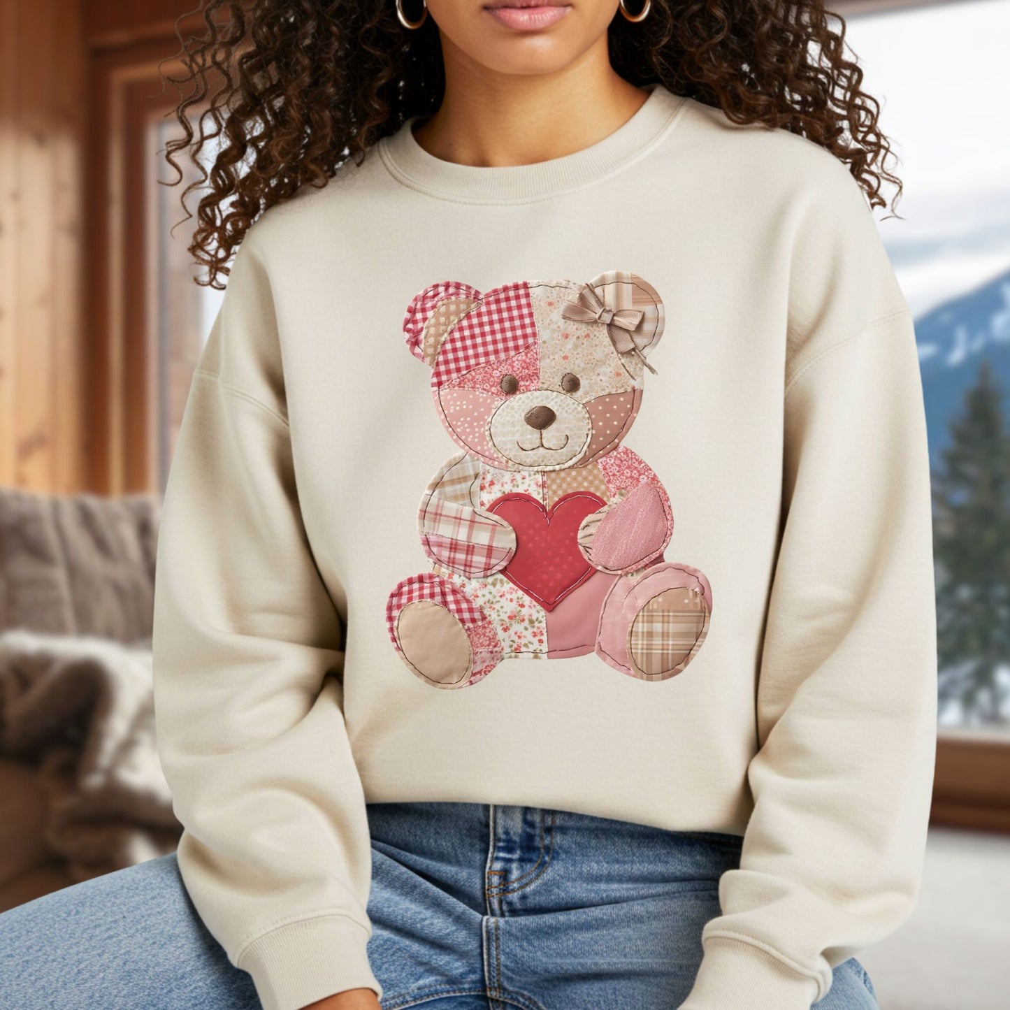 Cream unisex sweatshirt with a vintage faux patchwork teddy bear holding a red heart.
