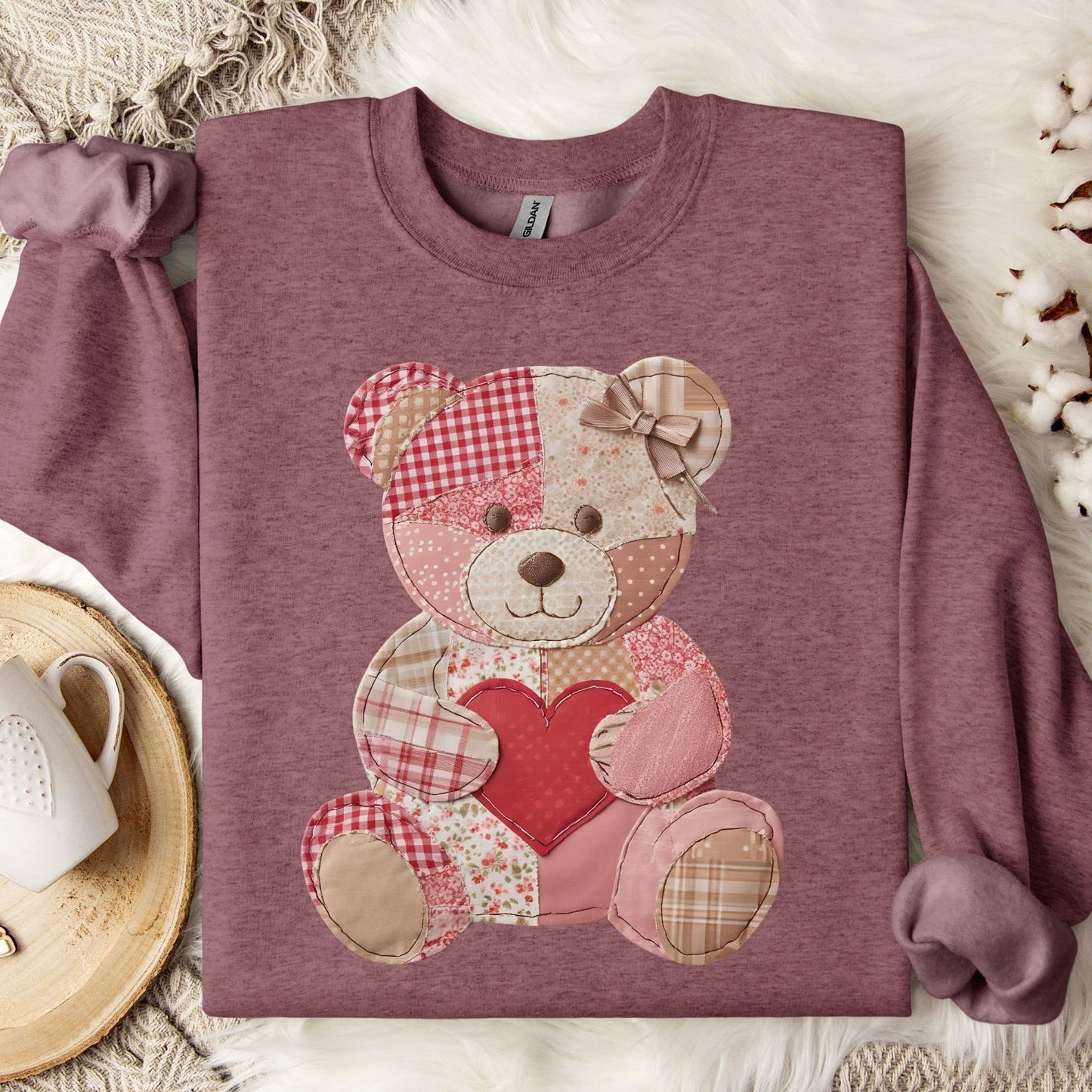 Heather Sport Dark Maroon sweatshirt with a faux patchwork teddy bear holding a red heart.