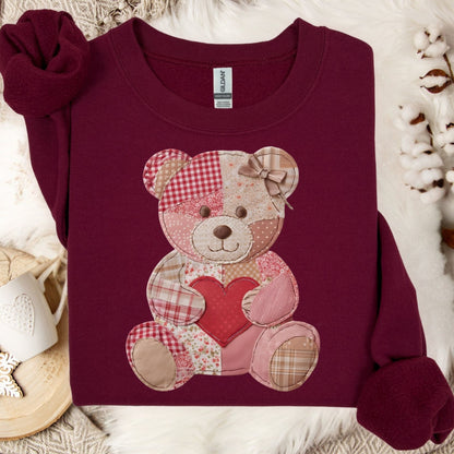 Maroon crewneck sweatshirt with a vintage patchwork teddy bear holding a red heart.