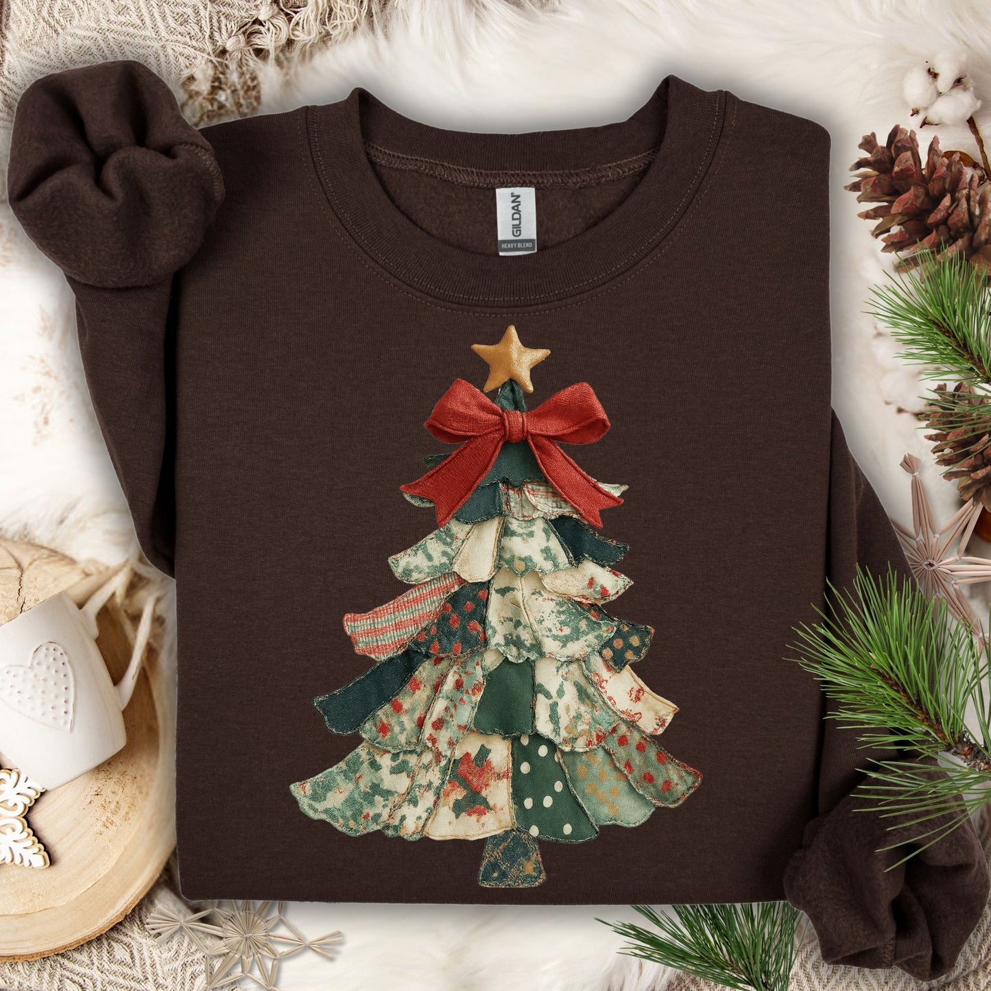 Dark chocolate sweatshirt with a vintage-inspired patchwork Christmas tree design, featuring a red bow and gold star.