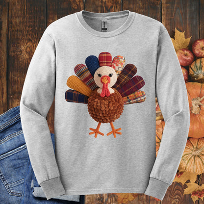 Ash gray long sleeve tee with a faux patchwork turkey, hook yarn body, and colorful plaid feathers.