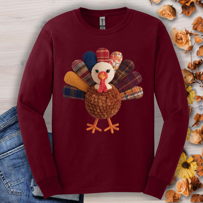 Maroon cotton long sleeve tee with a faux patchwork turkey, hook yarn body, and vintage fall tones.