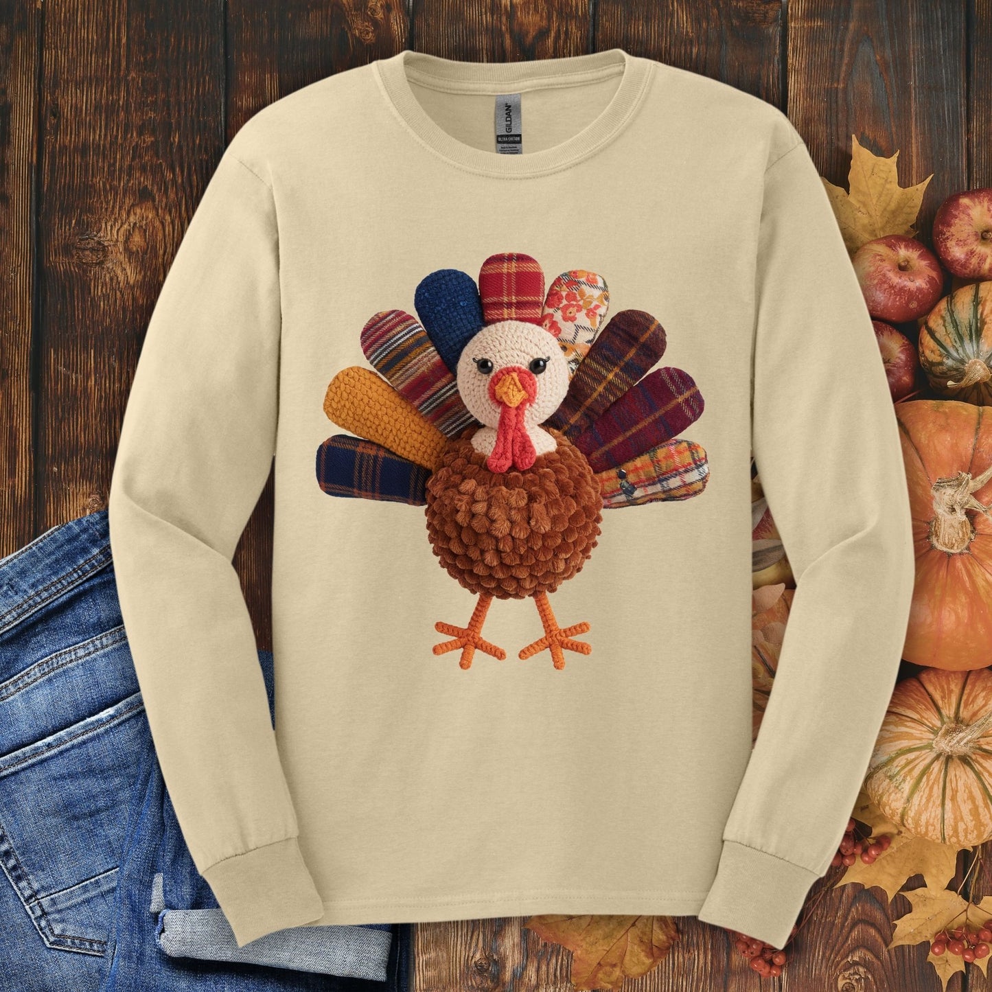 Sand long sleeve tee with a faux patchwork turkey and hook yarn body design.