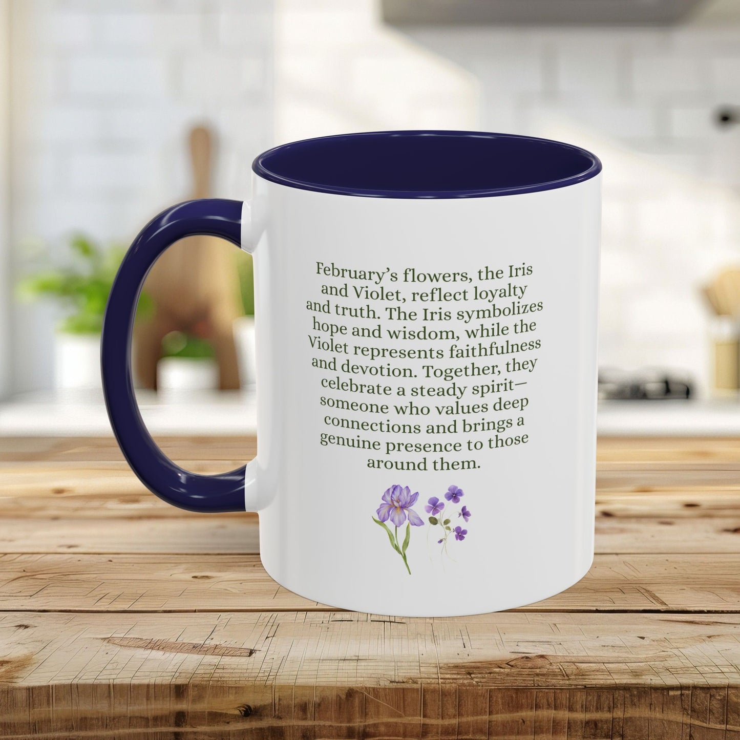 White ceramic mug with a navy interior and handle, featuring green text about February flowers and purple watercolor irises.