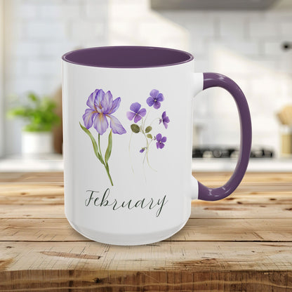 White 15oz ceramic mug with purple interior and handle, featuring watercolor iris and violet blooms and "February" text.