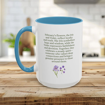 White ceramic mug with blue handle and interior, featuring text about February birth flowers and watercolor iris and violet blooms.