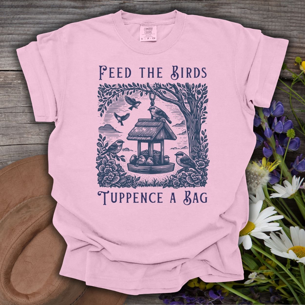 Blossom pink unisex t-shirt with vintage bird feeder illustration and "Feed the Birds Tuppence a Bag" text.