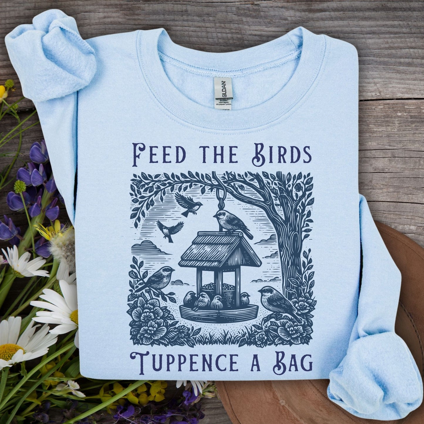 Light blue vintage sweatshirt with "Feed the Birds, Tuppence a Bag" text and bird feeder illustration.