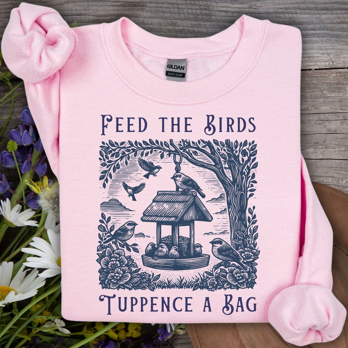 Light pink unisex sweatshirt with "Feed the Birds, Tuppence a Bag" vintage bird feeder illustration.
