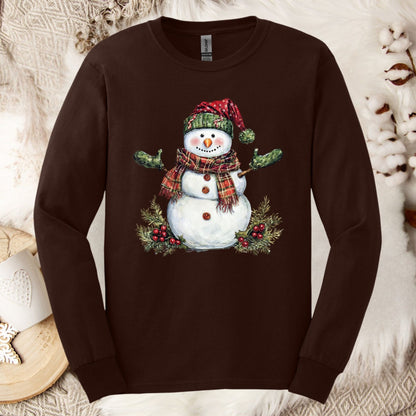 Dark chocolate long sleeve tee with a watercolor snowman in a plaid hat, scarf, and green gloves.