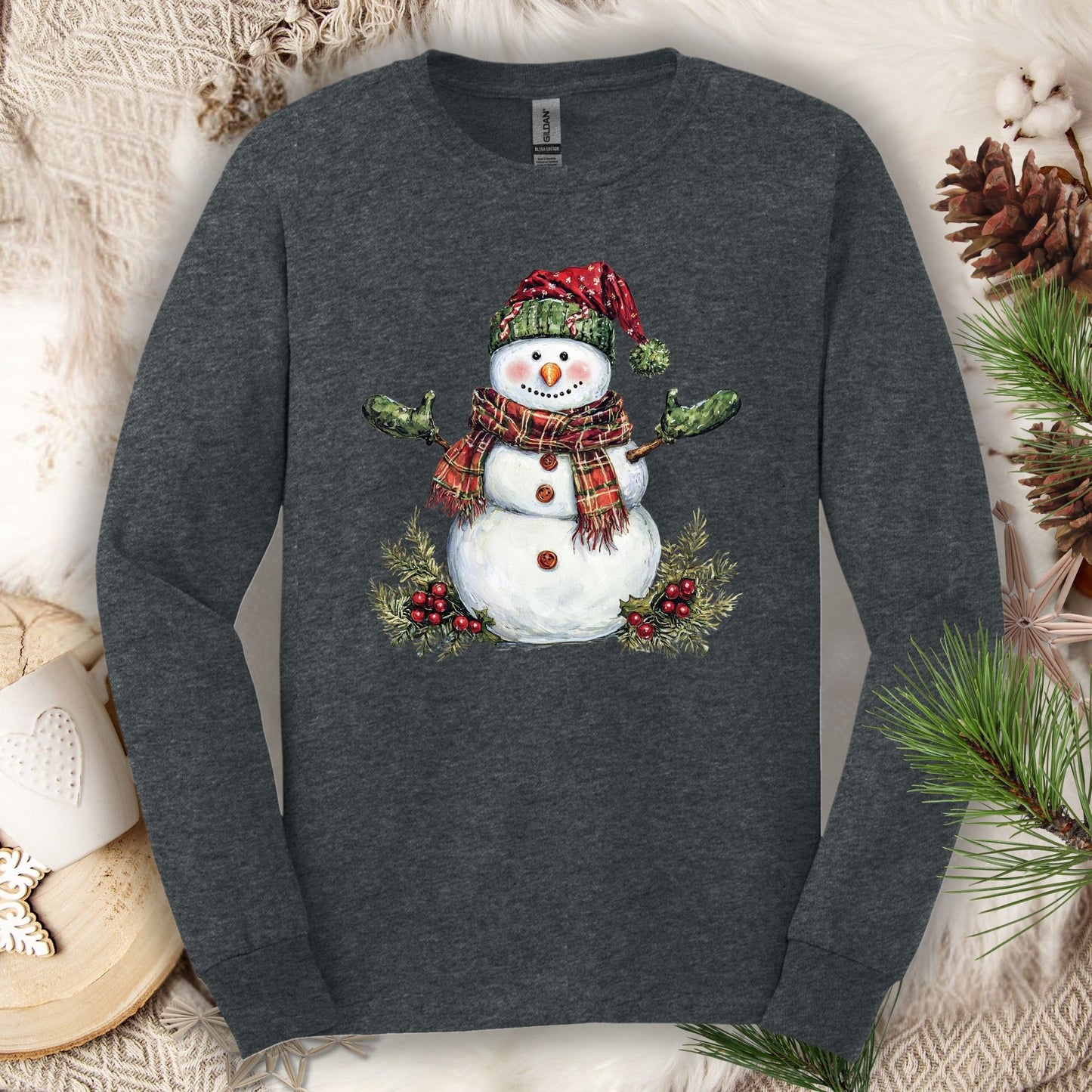 Dark Heather long sleeve tee with a watercolor snowman in a plaid hat, green gloves, and scarf.