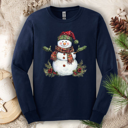 Navy long sleeve tee with a watercolor snowman in a plaid hat, green gloves, and scarf, surrounded by holly.