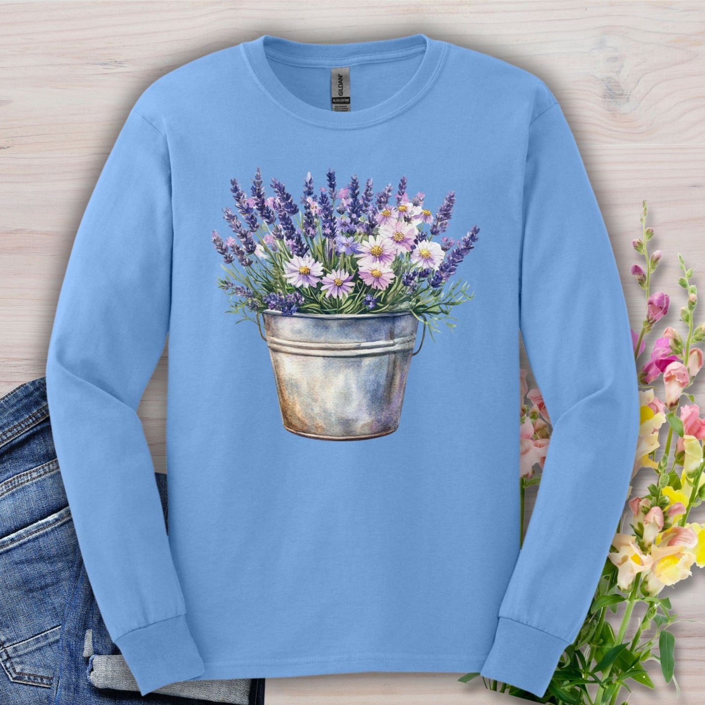 Carolina Blue long sleeve tee with a vintage-feel cotton, featuring a hand-painted lavender and daisy bouquet in a metal pail.