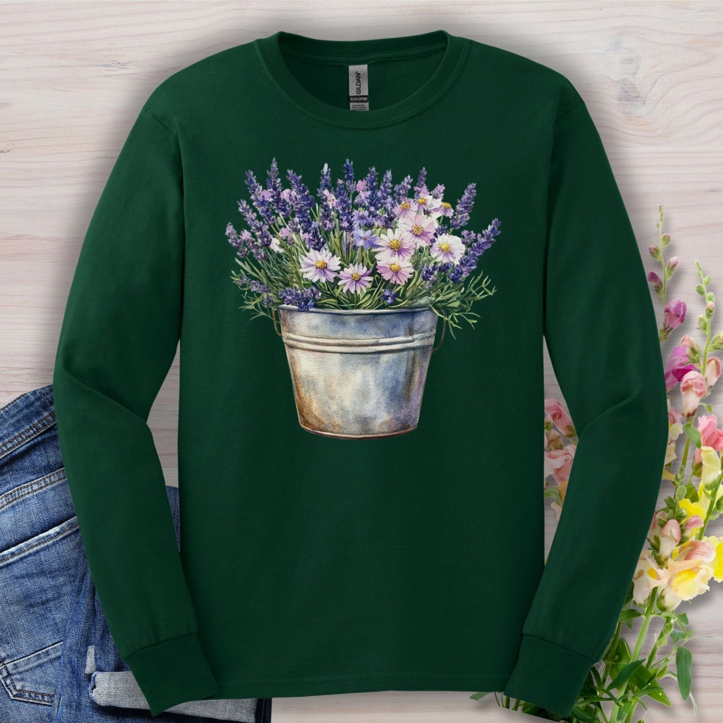 Forest green long sleeve tee with a hand-painted lavender and daisy bouquet in a weathered metal pail.