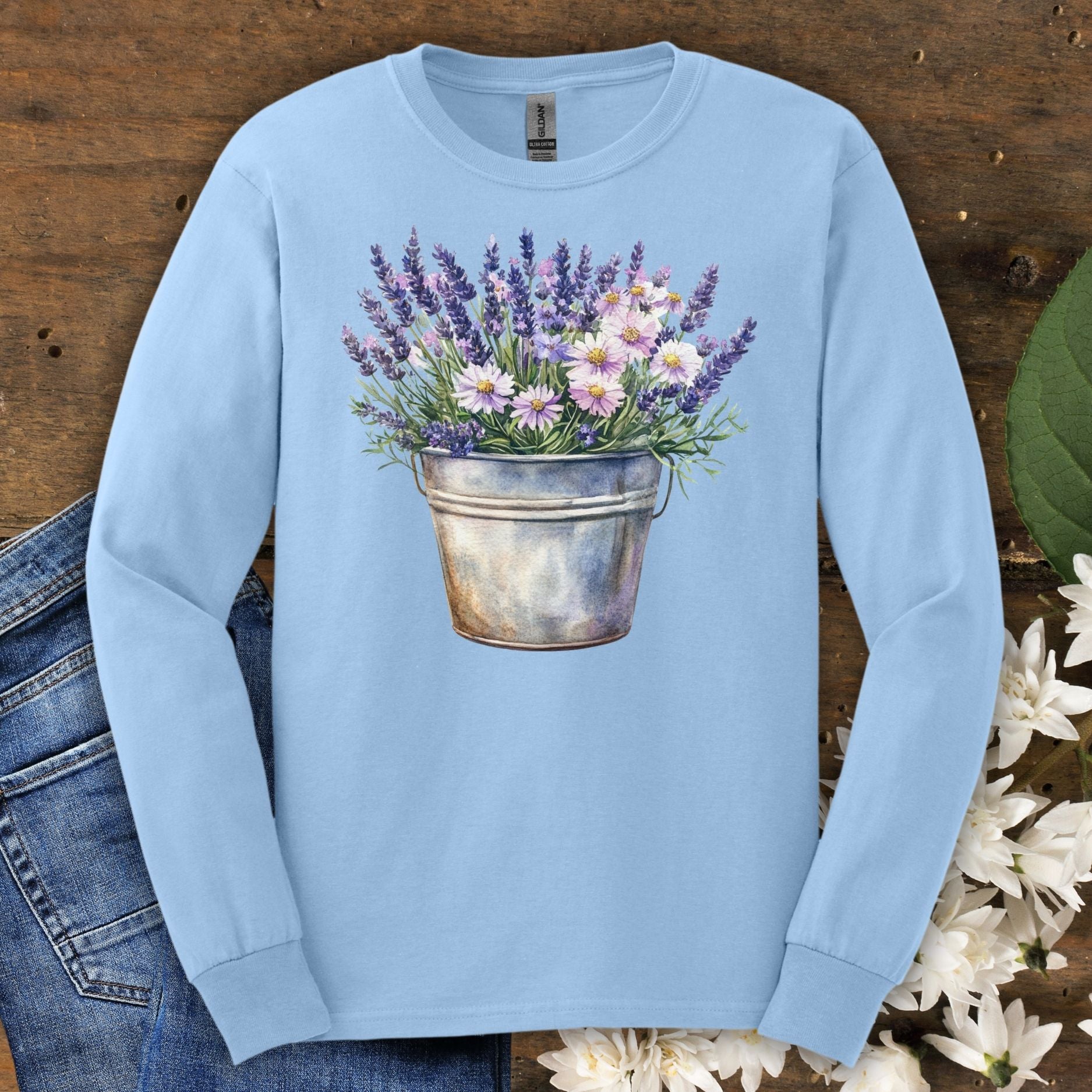 Light blue long sleeve tee with a hand-painted lavender and daisy bouquet in a weathered metal pail.