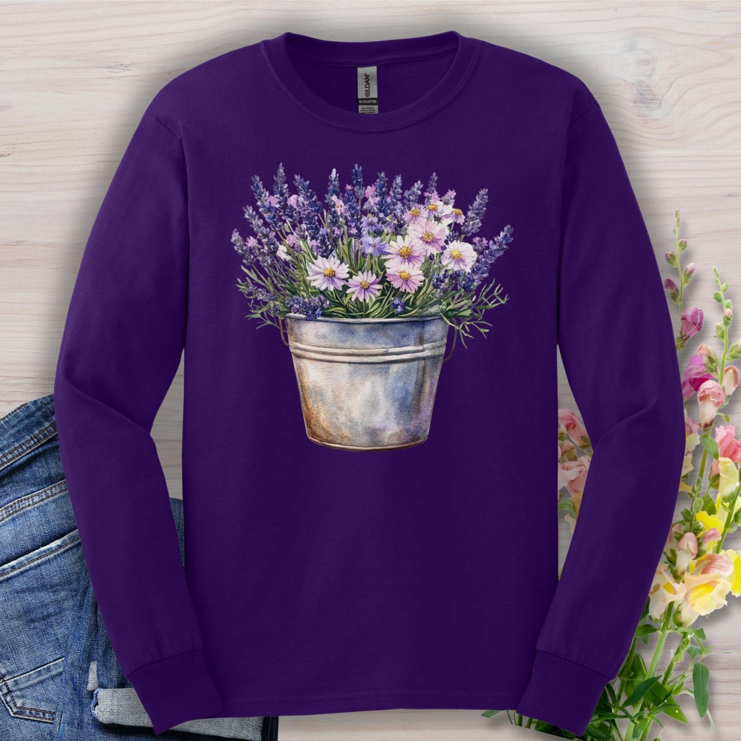 Purple long sleeve tee with a hand-painted lavender and daisy bouquet in a weathered metal pail.