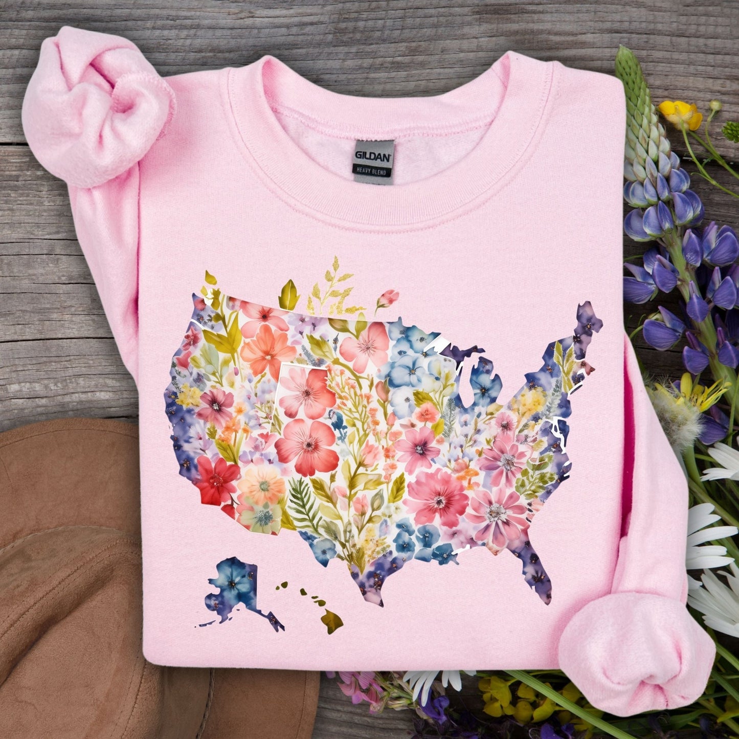 Light pink Gildan sweatshirt with a watercolor floral USA map design, surrounded by wildflowers.