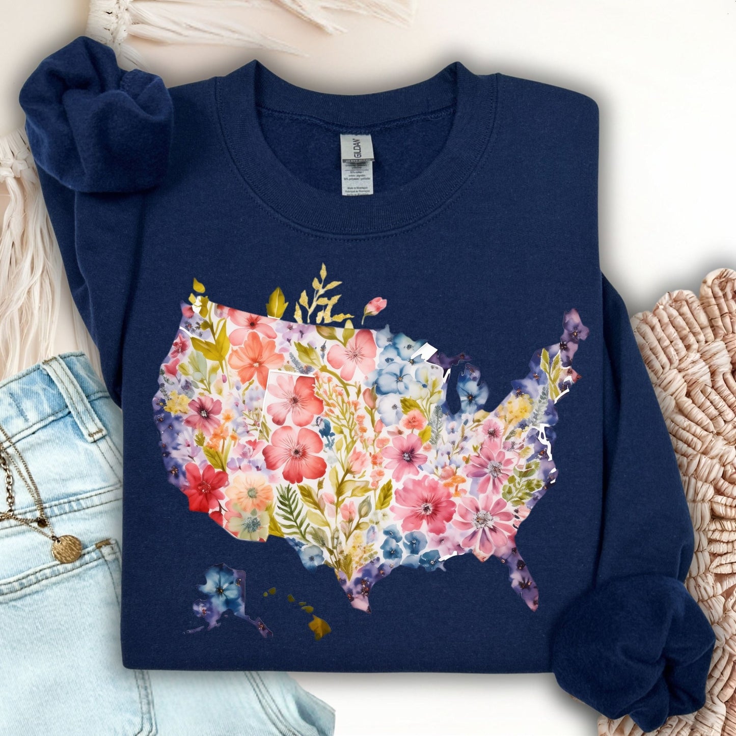 Navy Gildan sweatshirt with a watercolor floral USA map design, paired with jeans.
