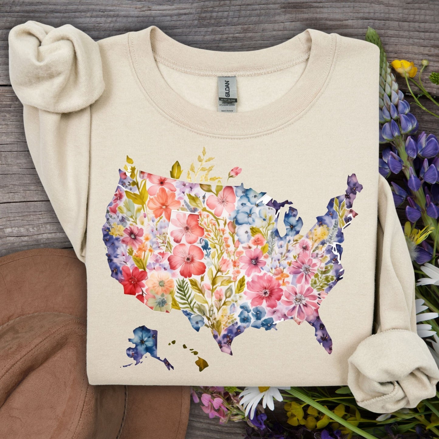 Sand Gildan sweatshirt with a watercolor floral map of the USA, surrounded by wildflowers.