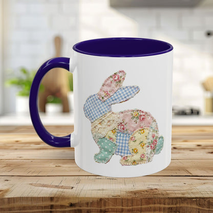 White ceramic mug with a purple handle and interior, featuring a patchwork floral Easter bunny design.