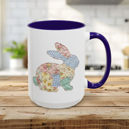 15oz white ceramic mug with blue interior/handle and a patchwork floral Easter bunny design.