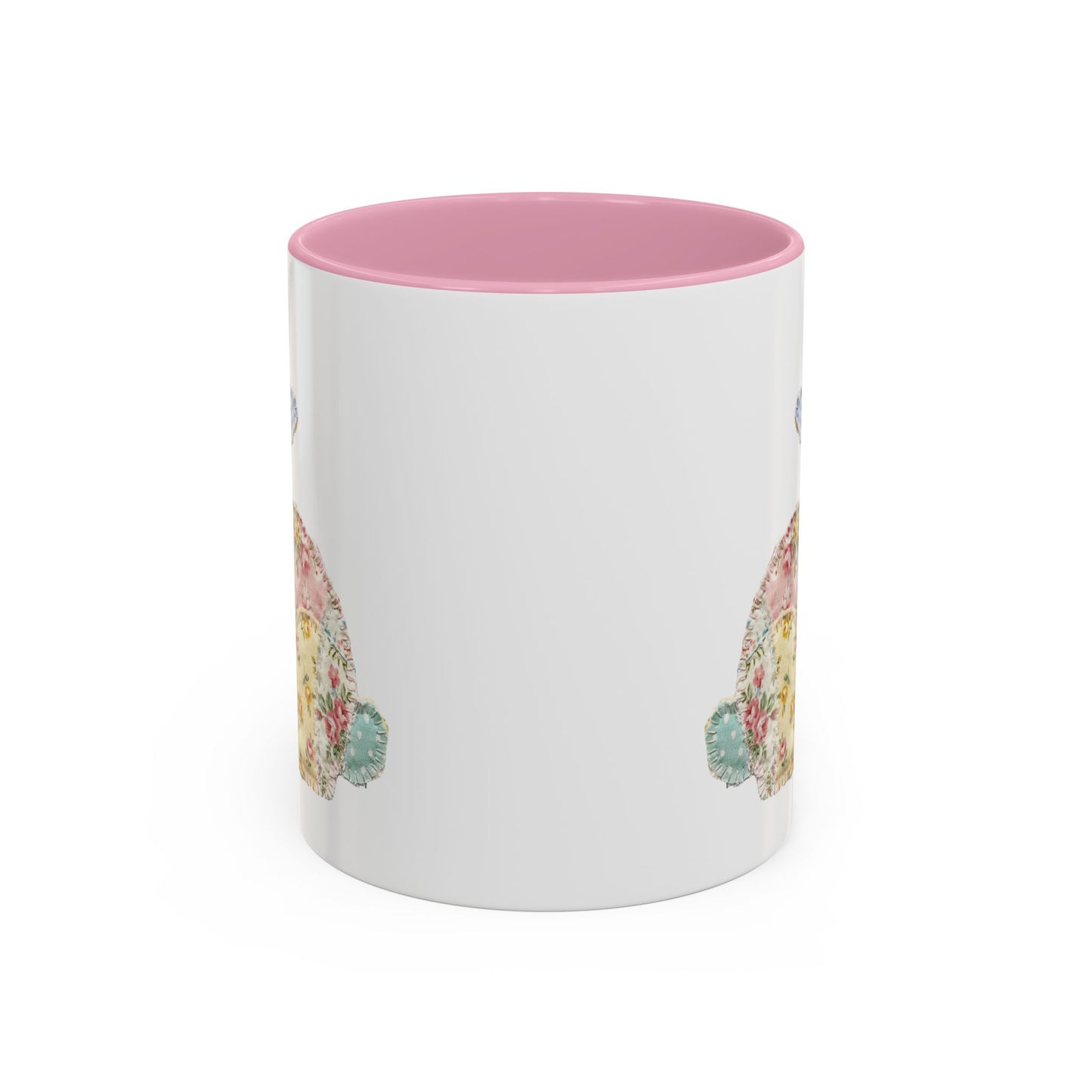 White ceramic mug with pink interior and handle, featuring a soft patchwork floral Easter bunny design.