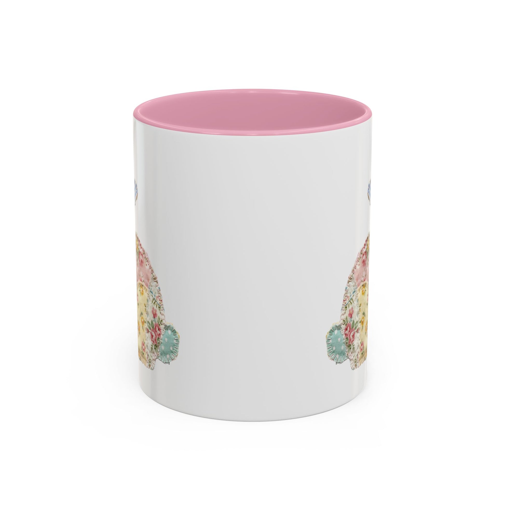 White ceramic mug with pink interior and handle, featuring a soft patchwork floral Easter bunny design.