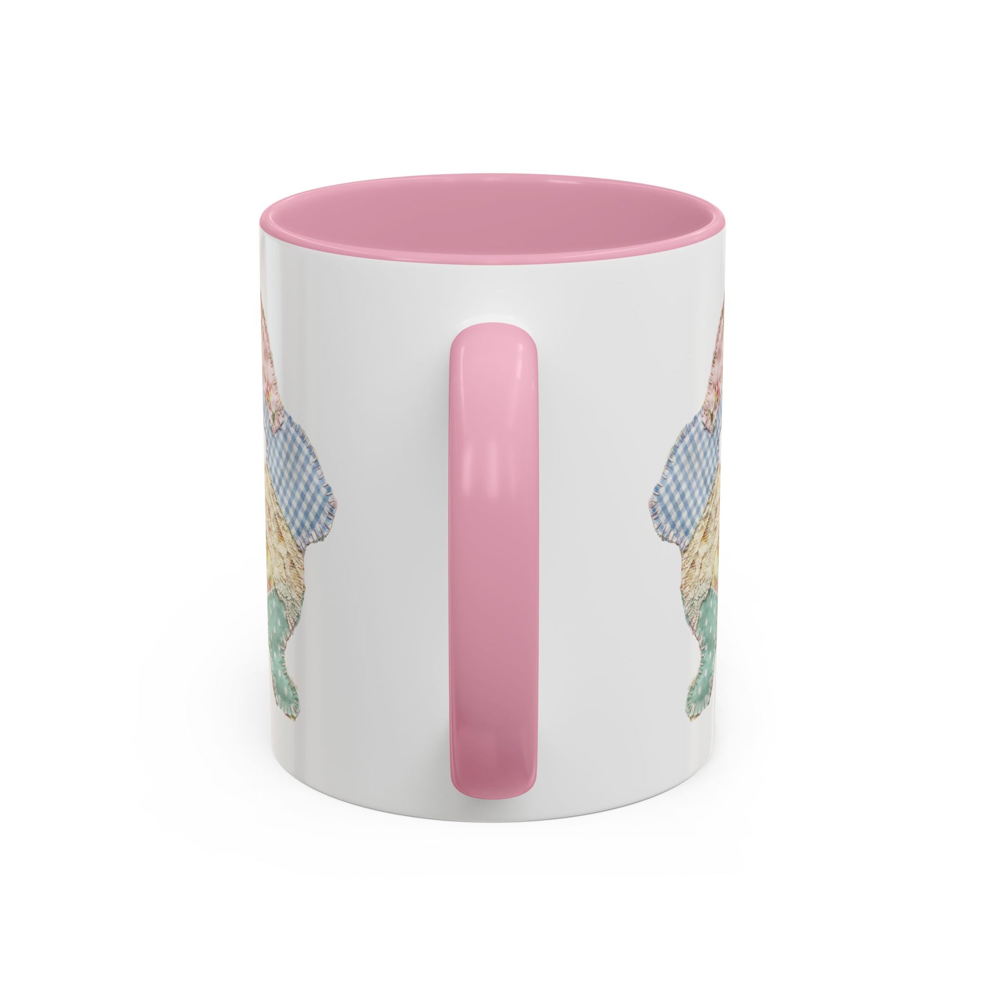White ceramic mug with pink handle and interior, featuring a patchwork floral Easter bunny design.