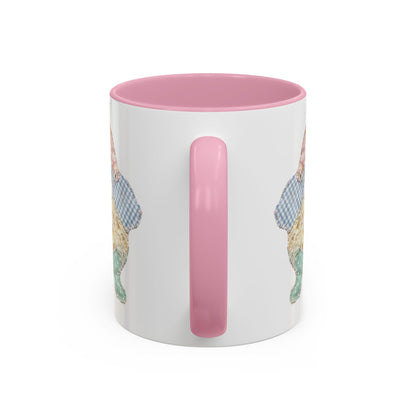 White ceramic mug with pink handle and interior, featuring a patchwork floral Easter bunny design.