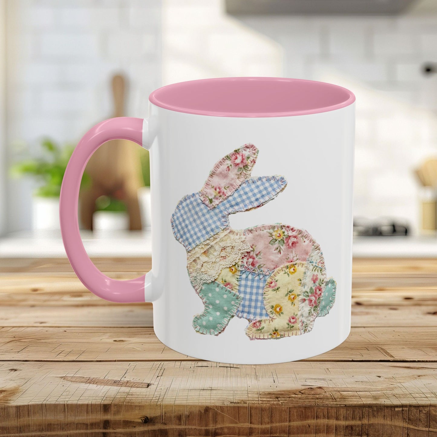 White ceramic mug with pink interior and handle, featuring a patchwork floral Easter bunny design.