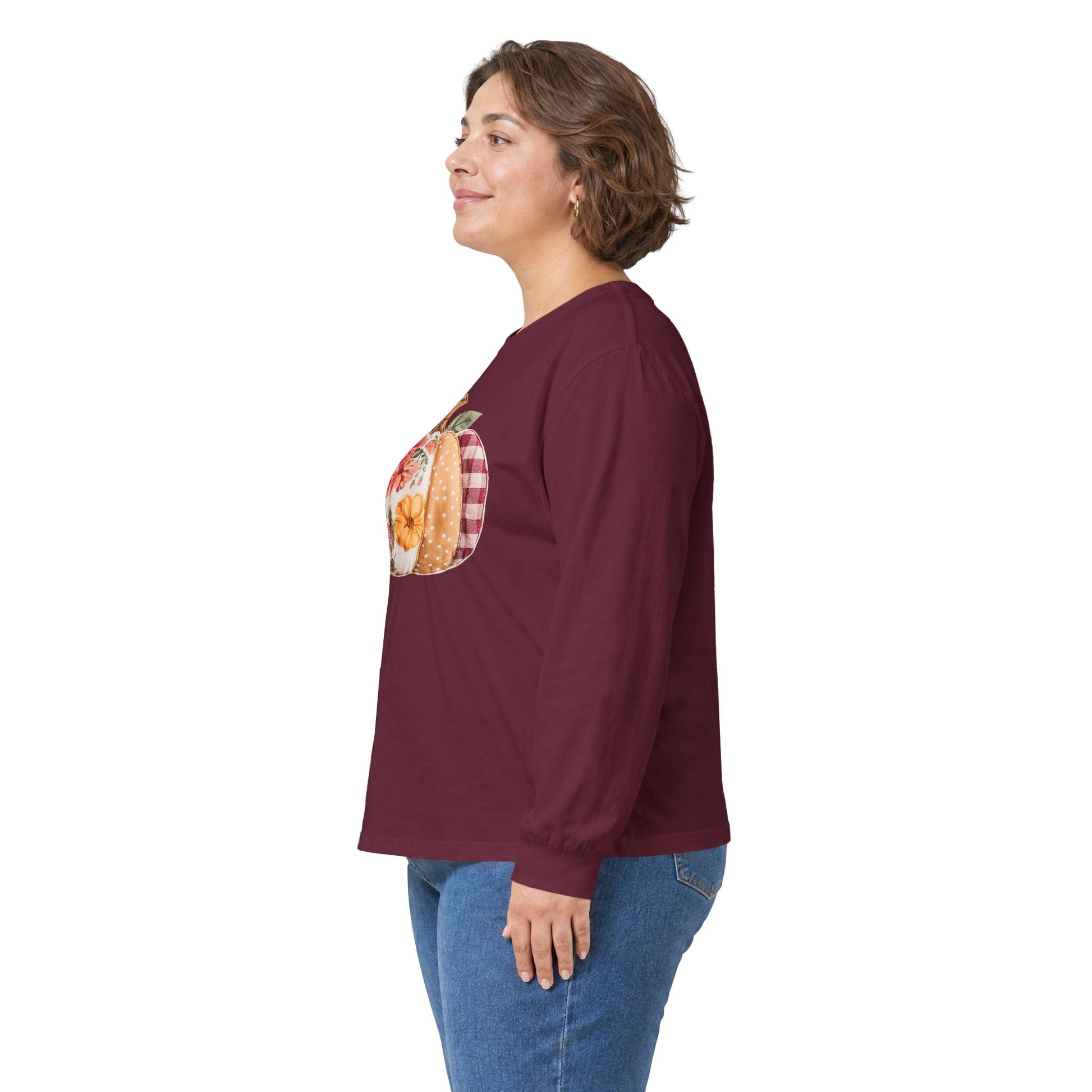 Woman in a maroon long-sleeve tee with a floral and plaid faux patchwork pumpkin design.