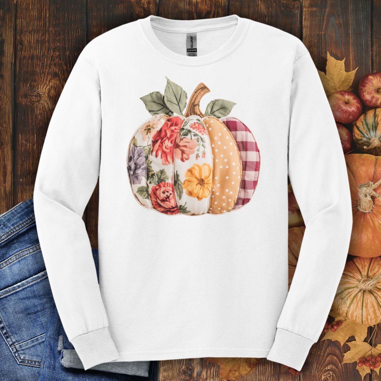 White long-sleeve tee with a faux patchwork pumpkin design featuring floral, gingham, and polka dot patterns.