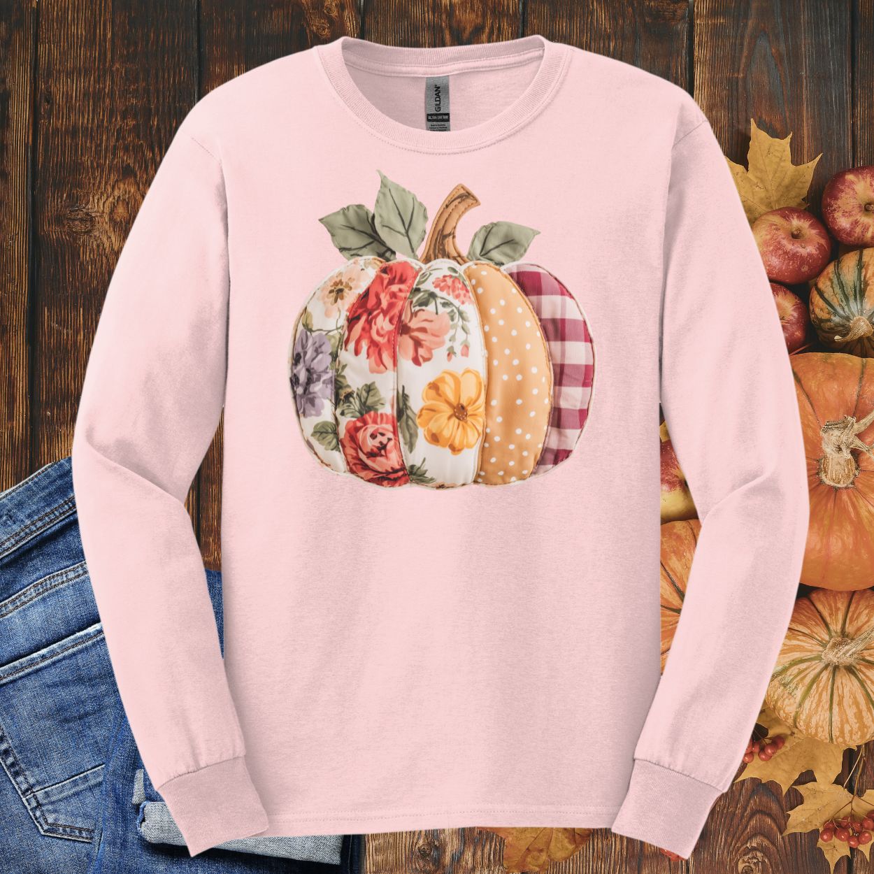 Light pink long sleeve tee with a faux patchwork pumpkin design featuring floral, plaid, and dotted patterns.
