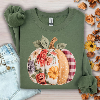 Military green sweatshirt with a faux patchwork pumpkin design featuring floral, gingham, and polka dot patterns.