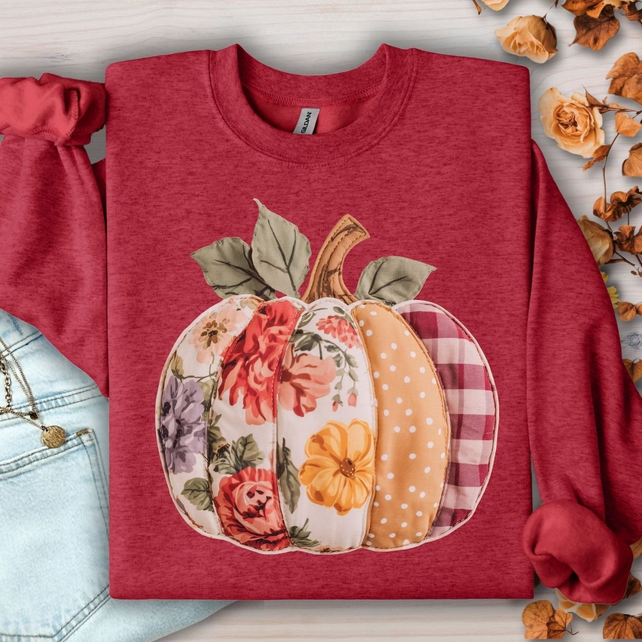 Antique Cherry Red sweatshirt with a faux patchwork pumpkin design in floral, gingham, and polka dot patterns.