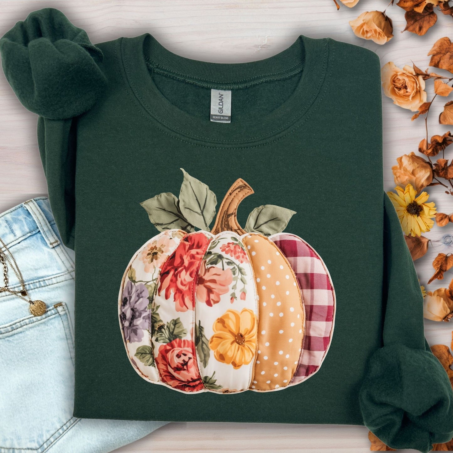 Forest Green sweatshirt with a faux patchwork pumpkin design featuring floral, gingham, and polka dot patterns.