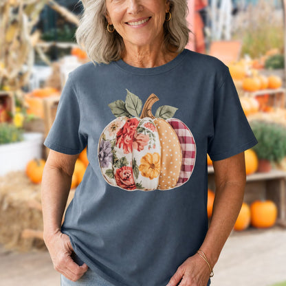 Woman in a Comfort Colors blue tee with a floral & plaid faux patchwork pumpkin design.