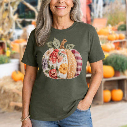 Woman in a Comfort Colors olive green t-shirt with a floral and plaid patchwork pumpkin design.
