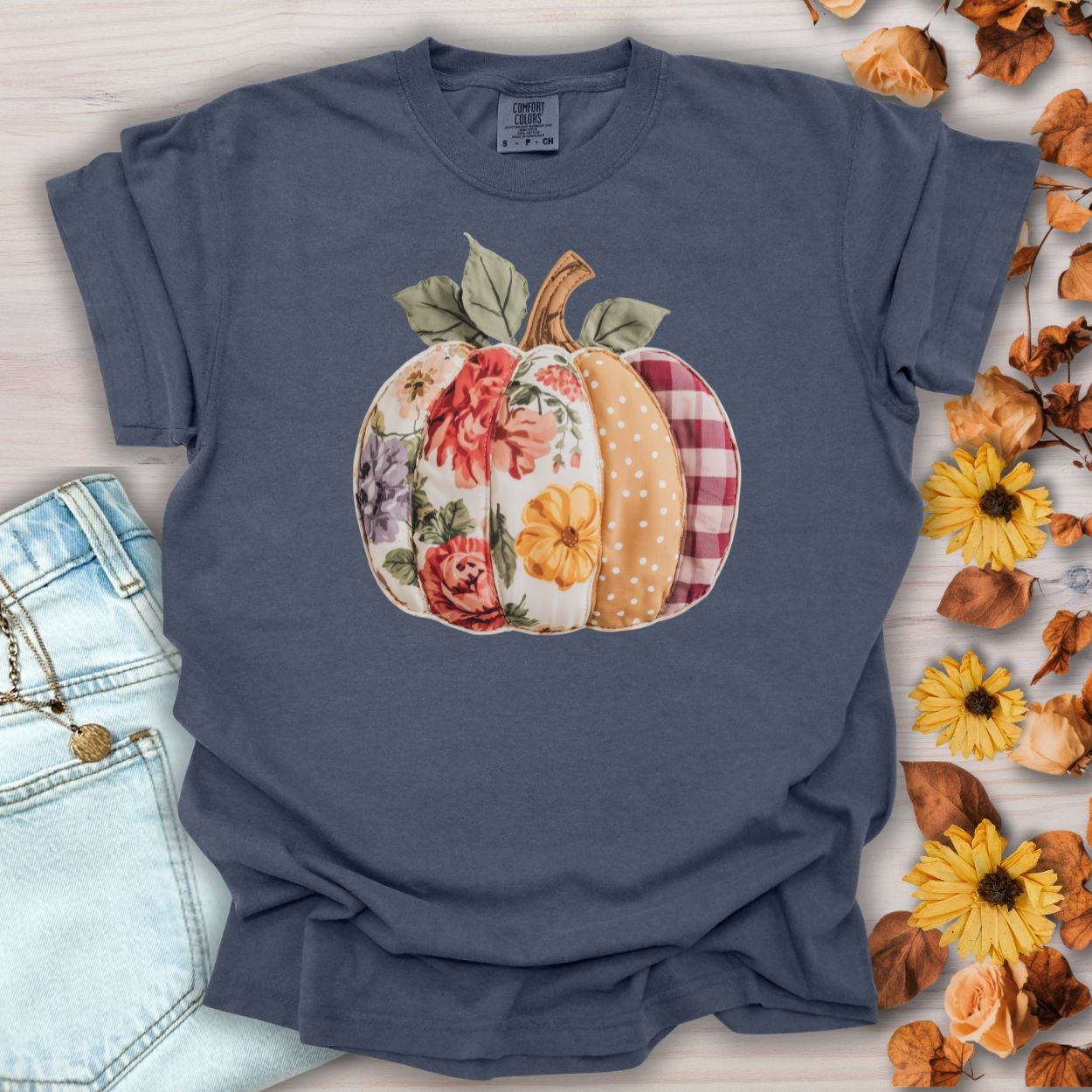 Denim Comfort Colors tee with a faux patchwork pumpkin featuring floral, plaid, and dotted patterns.