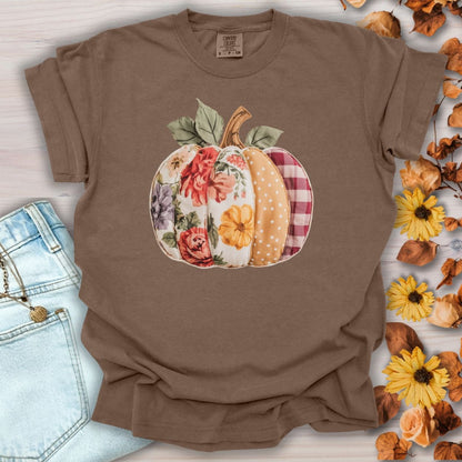 Espresso Comfort Colors tee with a faux patchwork pumpkin design featuring florals, gingham, and polka dots.